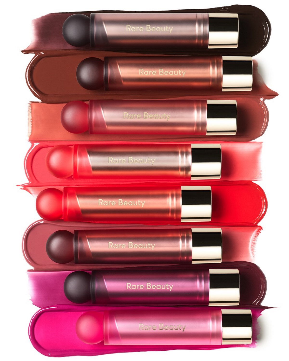 Вісім стіків Rare Beauty Soft Pinch Lip Oil Stick на мазках відповідних відтінків