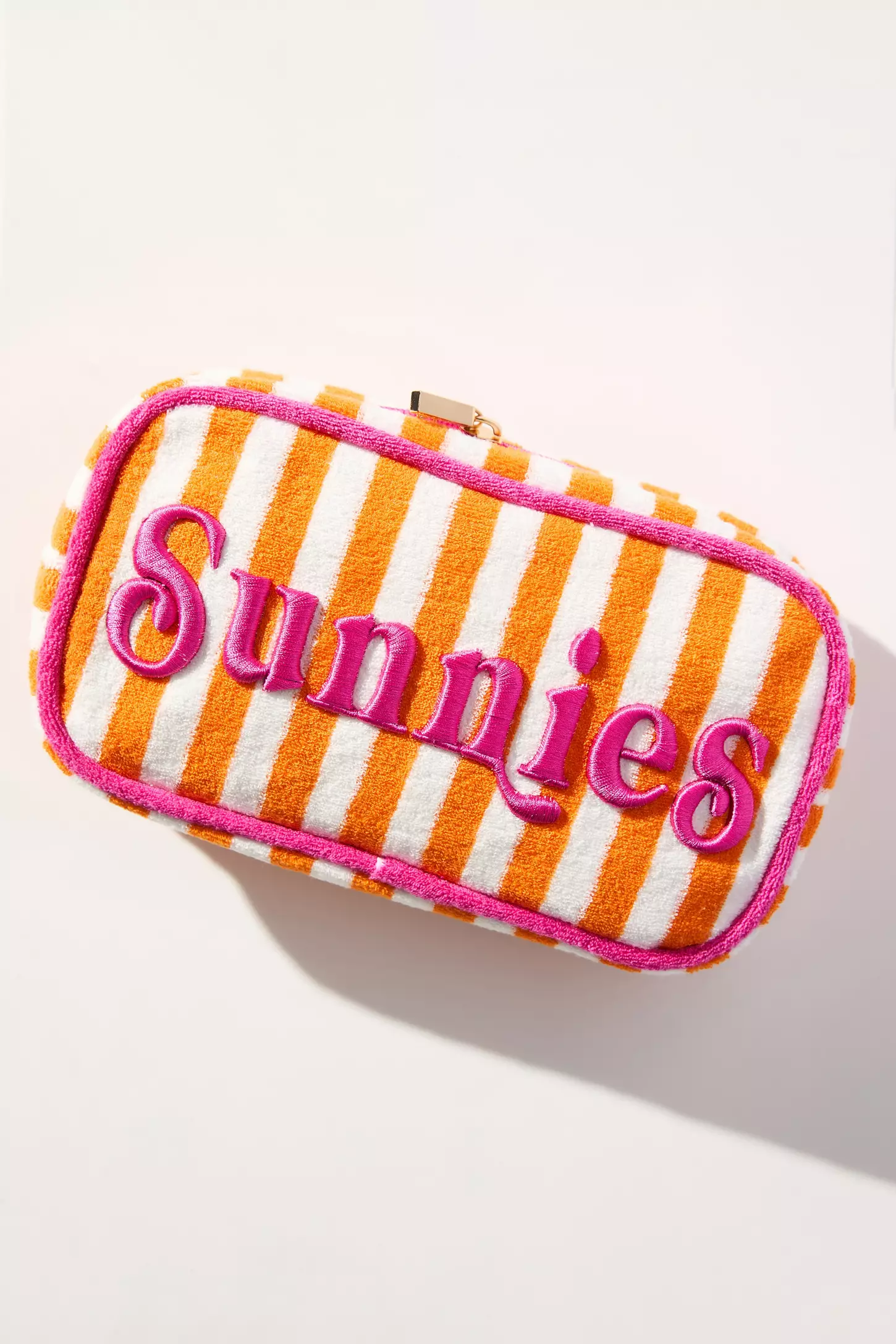 Помаранчево-біла махрова косметичка з написом Sunnies на світлому фоні