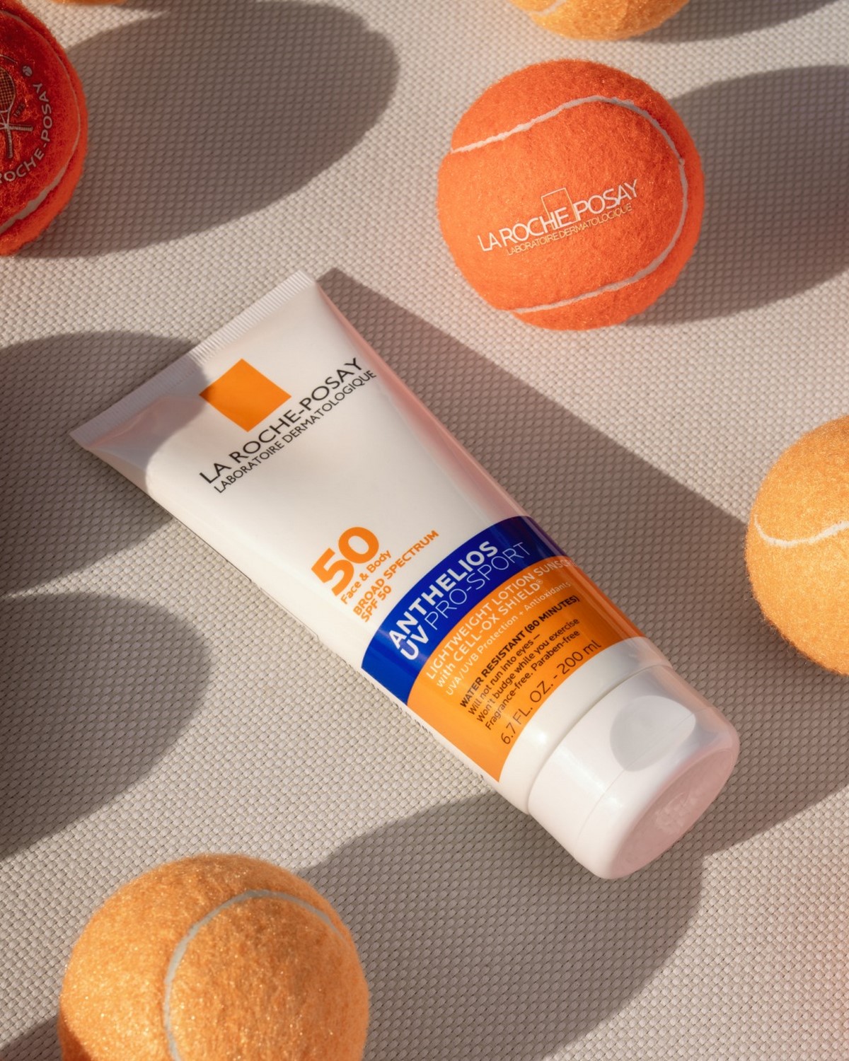 La Roche-Posay Anthelios UV Pro-Sport SPF 50 поруч із тенісними м’ячами